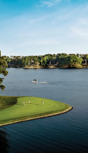 Aerial view of Reynolds Lake Oconee golf course fairways and lake on a clear summer day