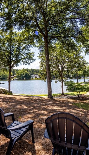 Aerial view of wooded peninsula on Lake Oconee with boat docks and calm water